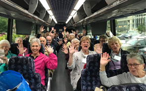 members on bus waving